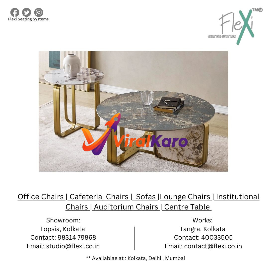 Two elegant round centre tables with marble-patterned tops and glossy gold U-shaped metallic bases from Flexi Seating Systems, placed on a light beige rug in a modern living room setting. The larger table holds a glass and a book, while the smaller side table features a white decorative vase.