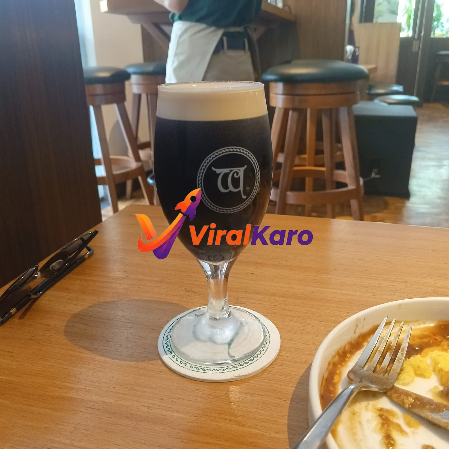 Craft stout beer at a local brewery with coaster and finished meal