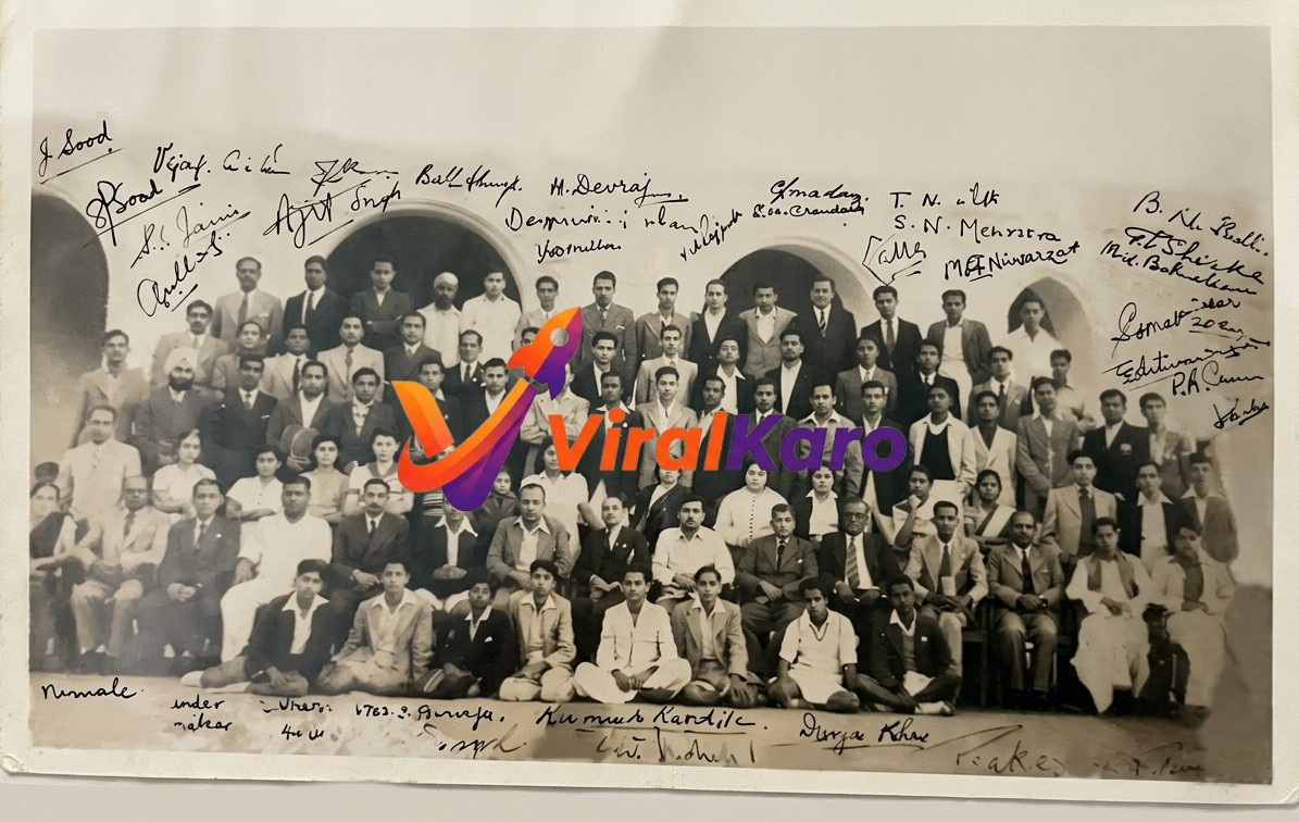A black and white vintage group photograph from the mid-20th century, showing a large assembly of Indian men and a few women, likely students or alumni. Many individuals are formally dressed, and the photo is extensively covered with handwritten signatures, possibly identifying each person. The background features arched doorways, suggesting an institutional building.